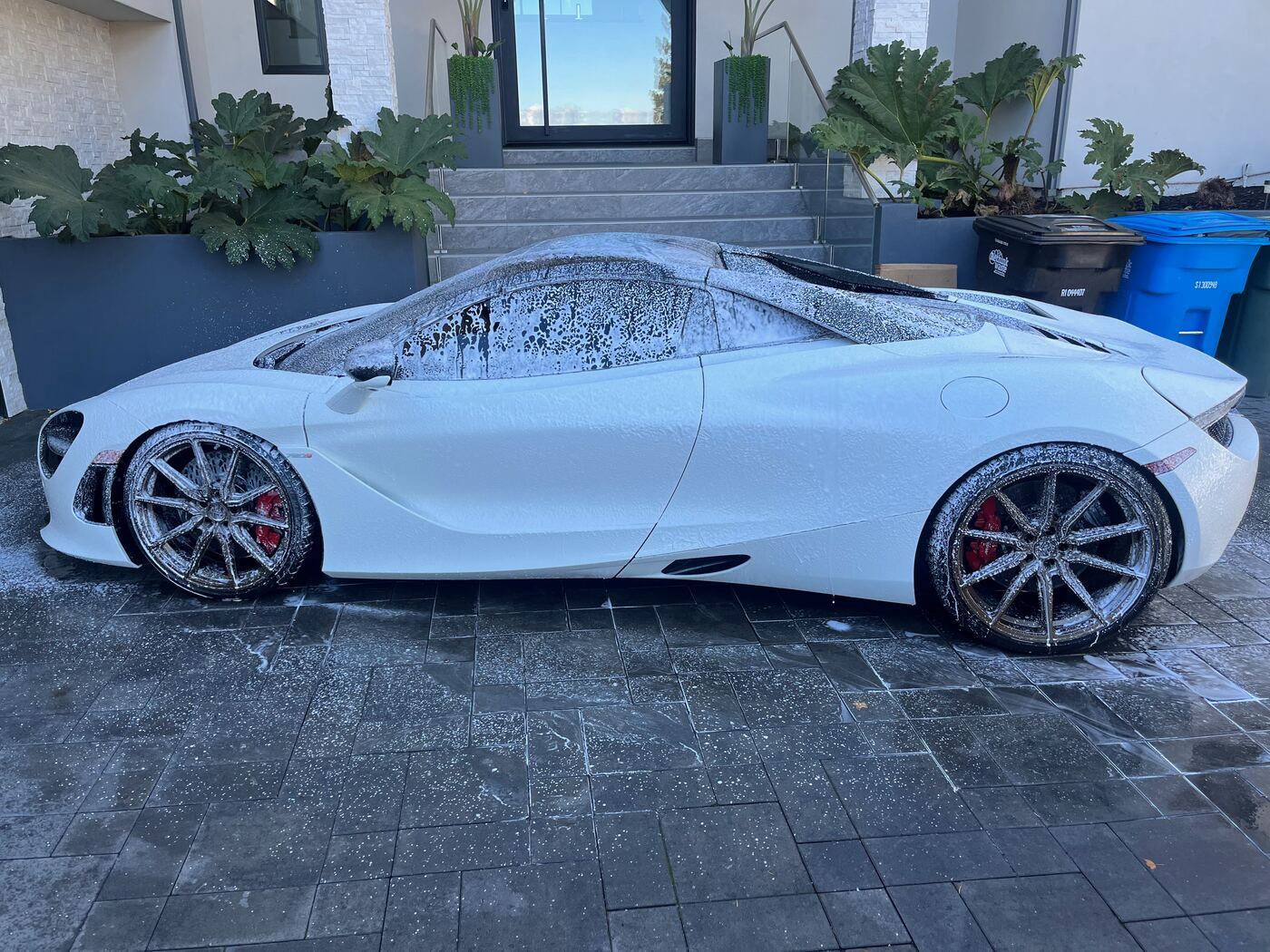 White McLaren 720S covered in wash foam